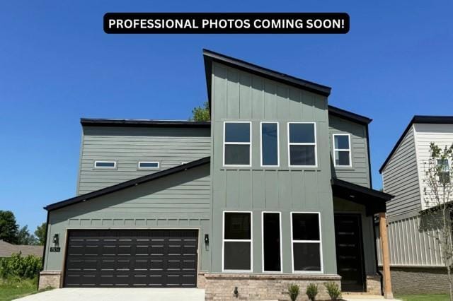 1304 SW Journey Ln, Bentonville, AR 72713 - view of front of property featuring board and batten siding, concrete driveway, brick siding, and an attached garage