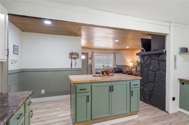 9402 Stone Ln, Omaha, AR 72662 - kitchen featuring green cabinets, butcher block countertops, light wood finished floors, a stone fireplace, and recessed lighting