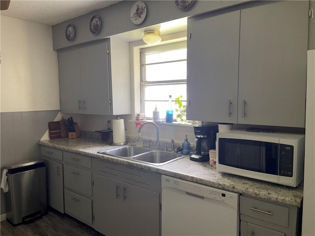315 Glines Ct, Harrison, AR 72601 - kitchen featuring stainless steel microwave, white dishwasher, light countertops, dark wood-style floors, and a textured ceiling