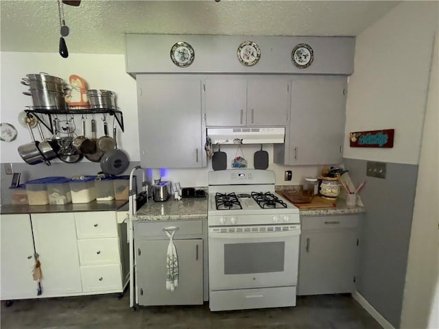 315 Glines Ct, Harrison, AR 72601 - kitchen featuring white range with gas cooktop, under cabinet range hood, a textured ceiling, concrete floors, and light countertops