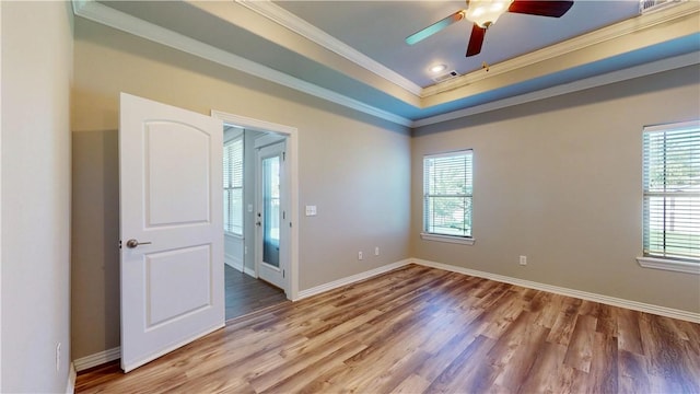 1218 Bradley St, Centerton, AR 72719 - spare room featuring ornamental molding, plenty of natural light, ceiling fan, light wood finished floors, and a tray ceiling