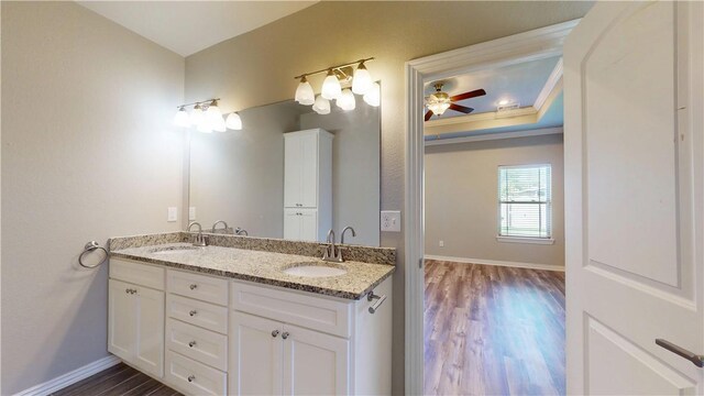 1218 Bradley St, Centerton, AR 72719 - bathroom featuring double vanity, wood finished floors, and ceiling fan