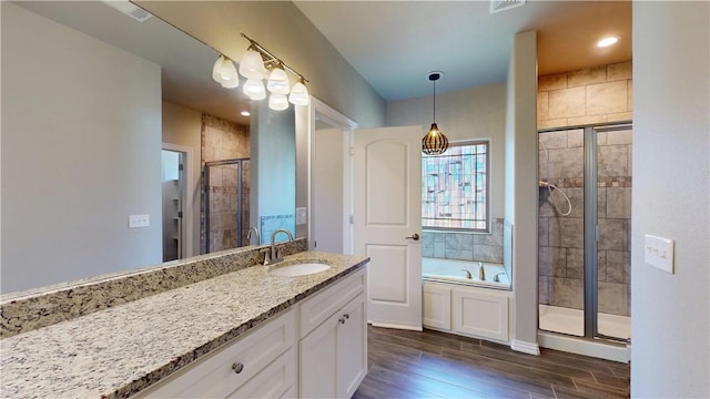 1218 Bradley St, Centerton, AR 72719 - bathroom featuring vanity, a stall shower, wood finished floors, and a bath