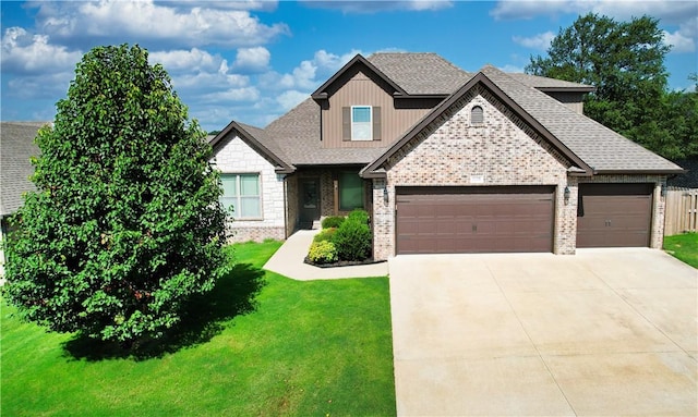 1218 Bradley St, Centerton, AR 72719 - craftsman-style home with an attached garage, a front lawn, driveway, brick siding, and a shingled roof