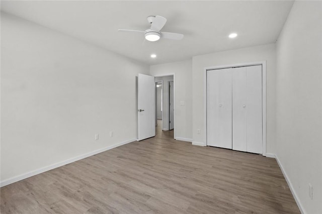 15654 Hickory Ln, Lowell, AR 72745 - unfurnished bedroom featuring wood finished floors, recessed lighting, ceiling fan, and a closet