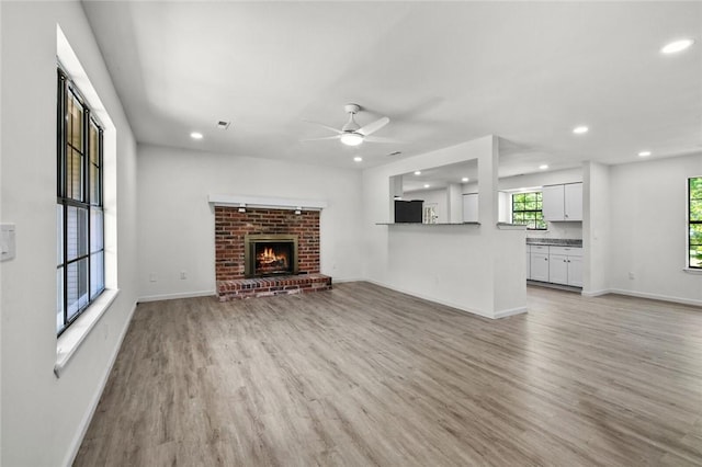 15654 Hickory Ln, Lowell, AR 72745 - unfurnished living room with recessed lighting, ceiling fan, light wood-type flooring, and a fireplace