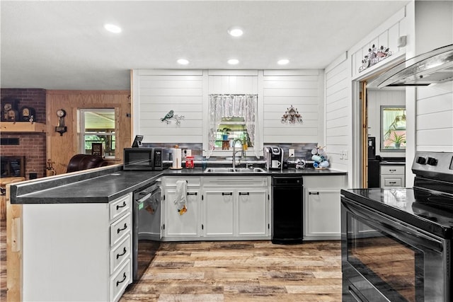 89 Creekview Rd, Harrison, AR 72601 - kitchen with black appliances, a peninsula, dark countertops, light wood-style flooring, and white cabinets