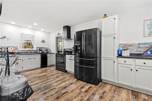 89 Creekview Rd, Harrison, AR 72601 - kitchen featuring refrigerator with ice dispenser, wall chimney range hood, electric range, dark countertops, and light wood finished floors