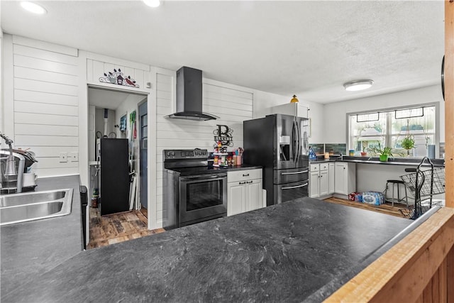 89 Creekview Rd, Harrison, AR 72601 - kitchen with appliances with stainless steel finishes, wall chimney exhaust hood, recessed lighting, wood finished floors, and white cabinetry