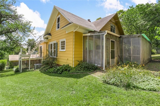 625 W College Ave, Harrison, AR 72601 - view of side of home with a sunroom, a lawn, and a wooden deck