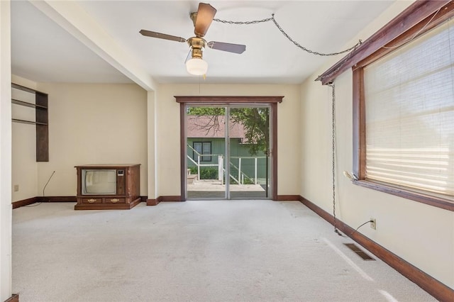 625 W College Ave, Harrison, AR 72601 - unfurnished living room featuring light colored carpet and ceiling fan
