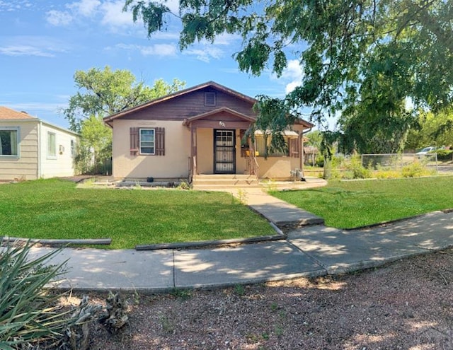 view of front of home with fence and a front yard