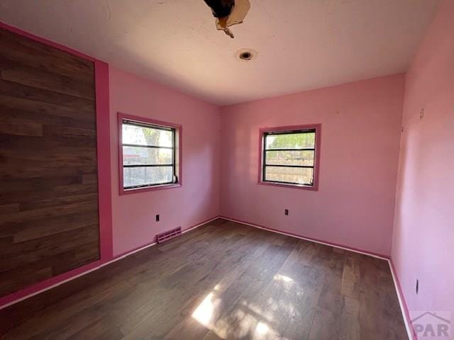 1726 W 12th St, Pueblo, CO 81003 - unfurnished room featuring plenty of natural light, wood finished floors, and visible vents