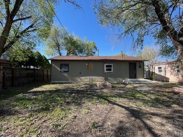 1726 W 12th St, Pueblo, CO 81003 - rear view of property with fence and stucco siding