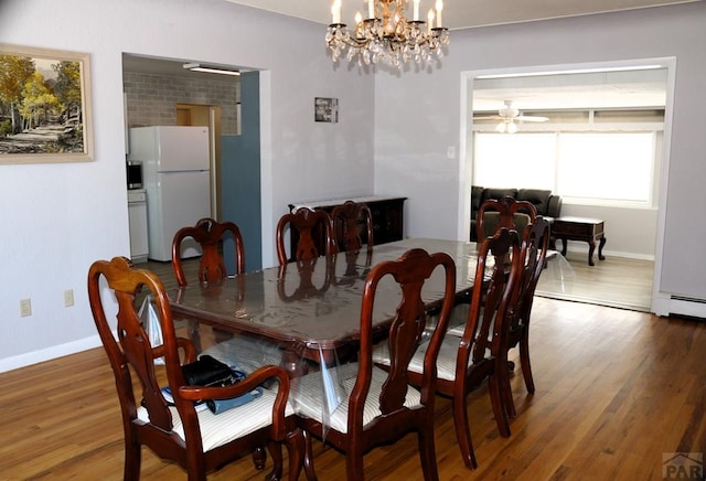 dining space featuring baseboards and wood finished floors