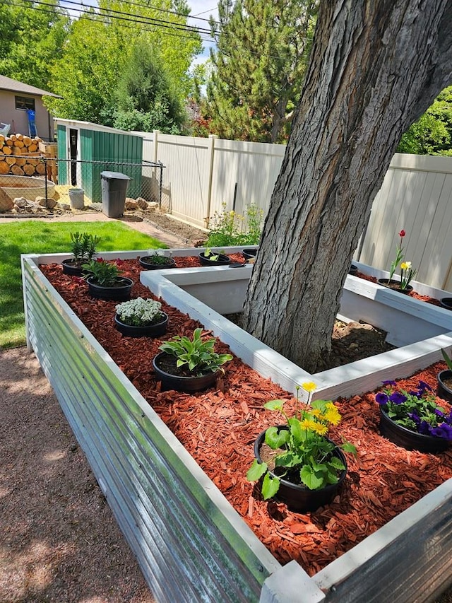 view of yard with fence and a vegetable garden