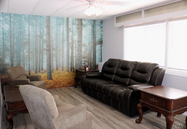 living area with light wood-type flooring and a ceiling fan