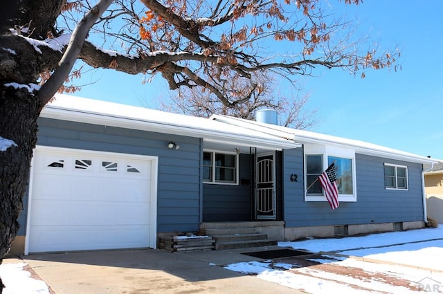 ranch-style home featuring concrete driveway, a chimney, and an attached garage