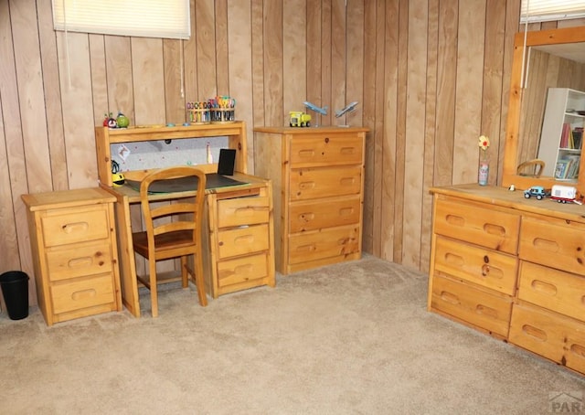 office area featuring light carpet and wooden walls