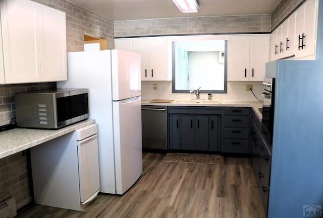 kitchen featuring dark wood-type flooring, a sink, white cabinetry, appliances with stainless steel finishes, and gray cabinets