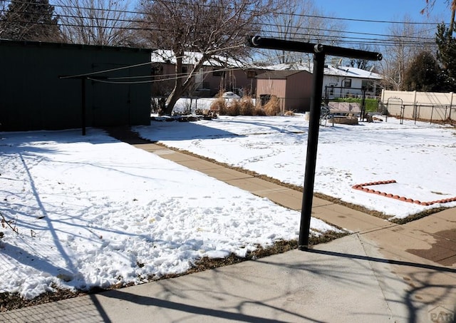 yard covered in snow with fence