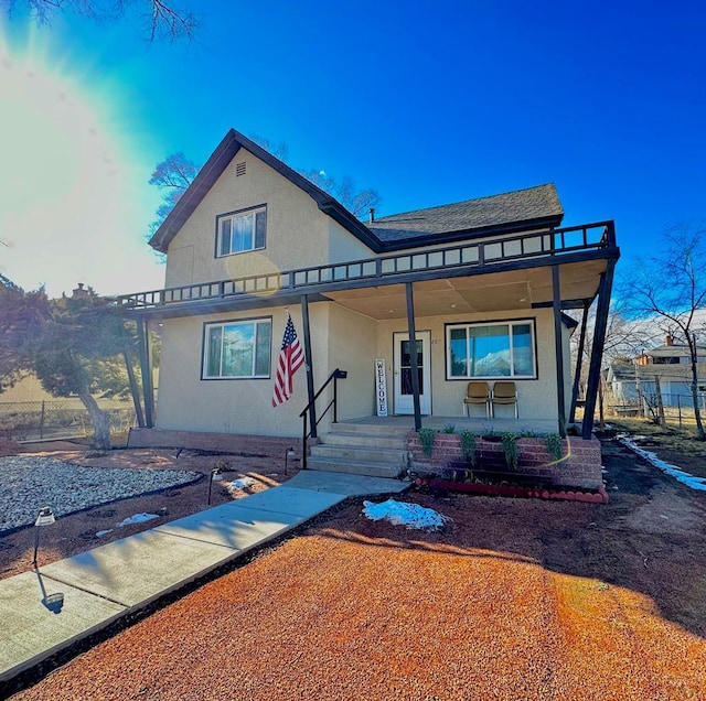 view of front of home with a porch and stucco siding