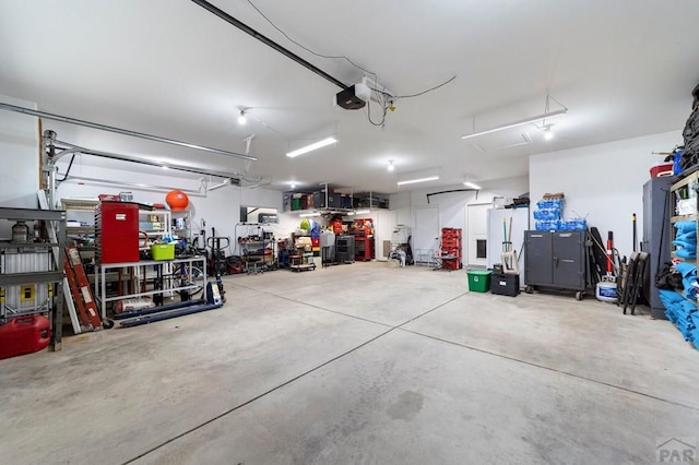 1037 W Desert Sage Dr, Pueblo West, CO 81007 - garage with freestanding refrigerator and a garage door opener