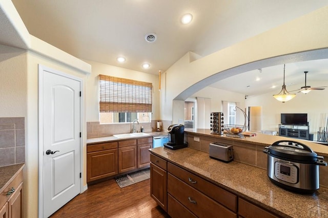 1037 W Desert Sage Dr, Pueblo West, CO 81007 - kitchen featuring a sink, stainless steel dishwasher, arched walkways, healthy amount of natural light, and recessed lighting
