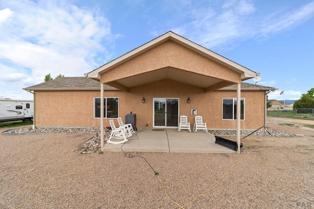 1037 W Desert Sage Dr, Pueblo West, CO 81007 - back of property featuring stucco siding and a patio area