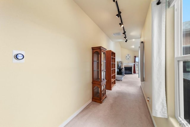 1037 W Desert Sage Dr, Pueblo West, CO 81007 - hallway featuring light carpet, track lighting, and baseboards