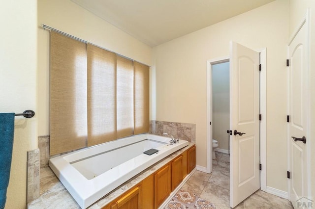 1037 W Desert Sage Dr, Pueblo West, CO 81007 - full bath featuring a bath, toilet, and tile patterned floors