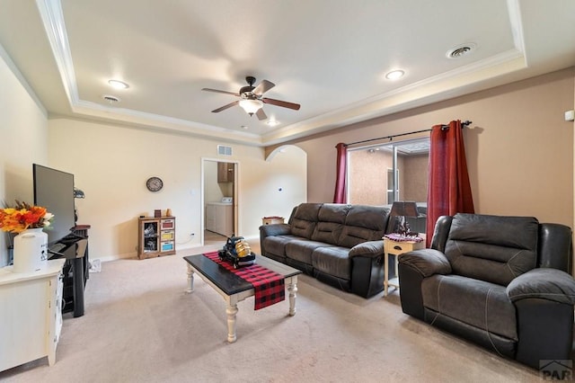 1037 W Desert Sage Dr, Pueblo West, CO 81007 - living room with a tray ceiling, light colored carpet, washer / dryer, a ceiling fan, and ornamental molding