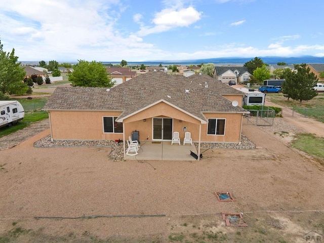 1037 W Desert Sage Dr, Pueblo West, CO 81007 - view of front facade with a patio, stucco siding, and a residential view