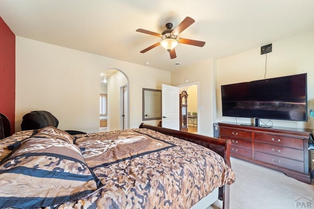1037 W Desert Sage Dr, Pueblo West, CO 81007 - bedroom with carpet, arched walkways, and ceiling fan