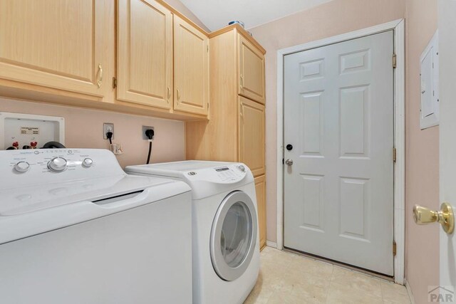 laundry room featuring light tile patterned floors, washing machine and dryer, and cabinet space