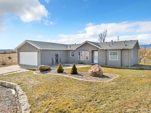 ranch-style house featuring concrete driveway, a front lawn, an attached garage, and stucco siding