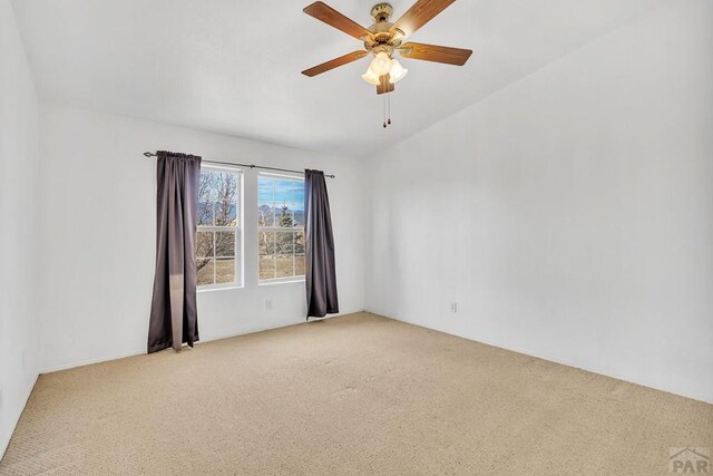 empty room with light carpet and a ceiling fan