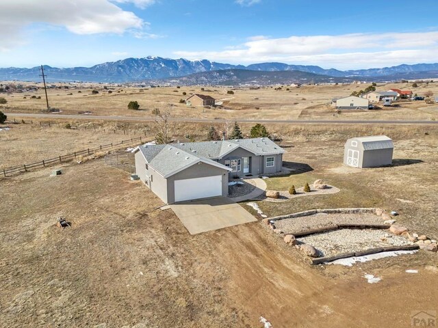 drone / aerial view featuring a mountain view and a rural view