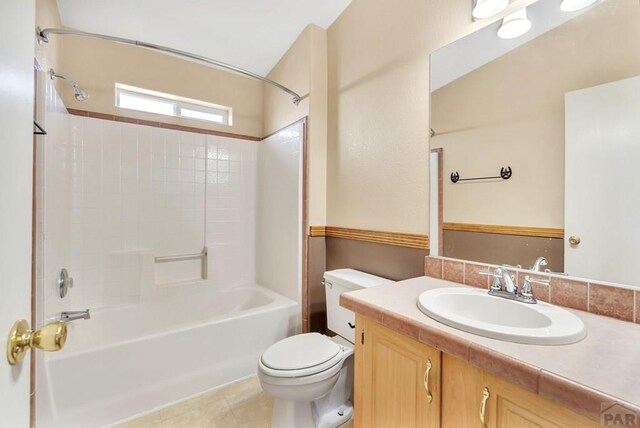 bathroom with shower / tub combination, vanity, toilet, and tile patterned floors