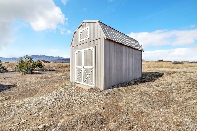 view of shed with a rural view and a mountain view