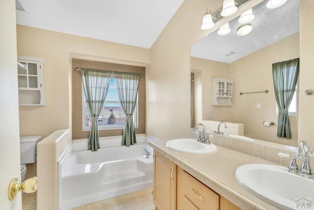 full bathroom featuring a garden tub, visible vents, a sink, and toilet