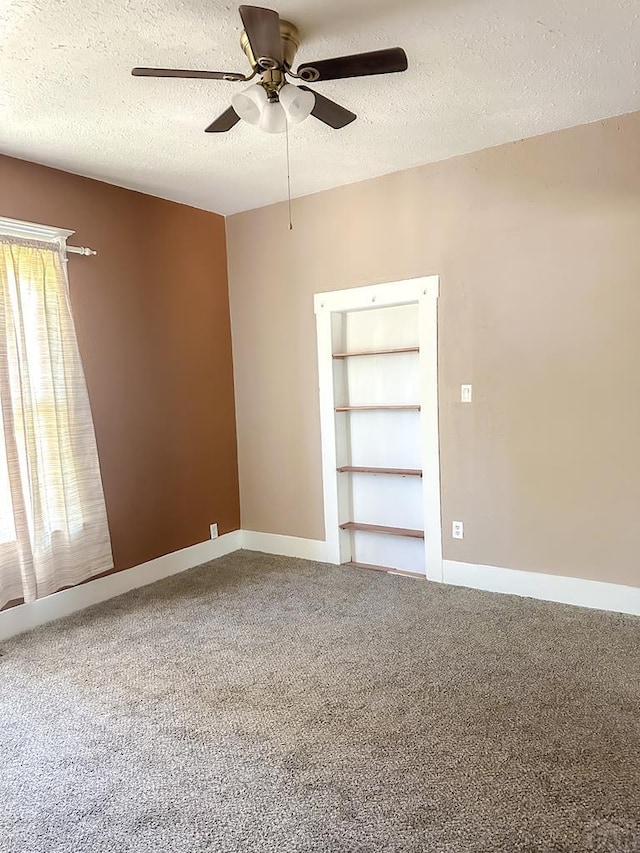 1202 Belleview Ave, La Junta, CO 81050 - carpeted spare room featuring ceiling fan and a textured ceiling