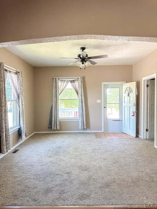 1202 Belleview Ave, La Junta, CO 81050 - carpeted empty room featuring a ceiling fan and a textured ceiling