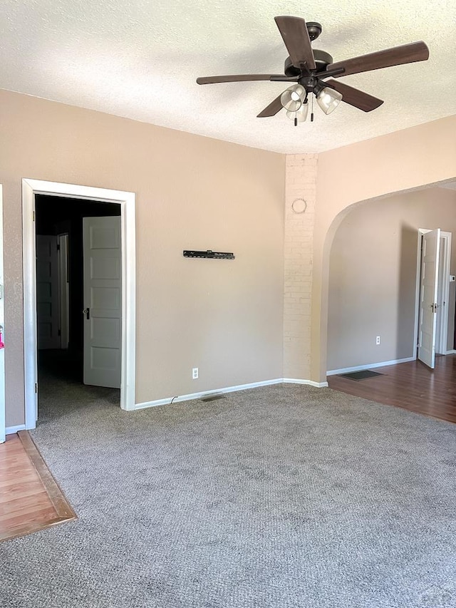 1202 Belleview Ave, La Junta, CO 81050 - carpeted spare room featuring arched walkways, a ceiling fan, and a textured ceiling