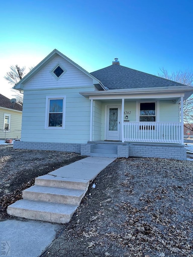 1202 Belleview Ave, La Junta, CO 81050 - bungalow-style house with a porch, a chimney, and roof with shingles