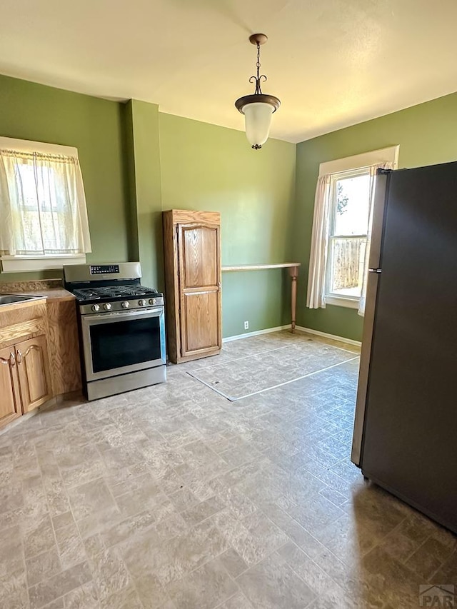 1202 Belleview Ave, La Junta, CO 81050 - kitchen with appliances with stainless steel finishes, healthy amount of natural light, and hanging light fixtures