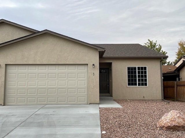 ranch-style home featuring roof with shingles, stucco siding, fence, a garage, and driveway