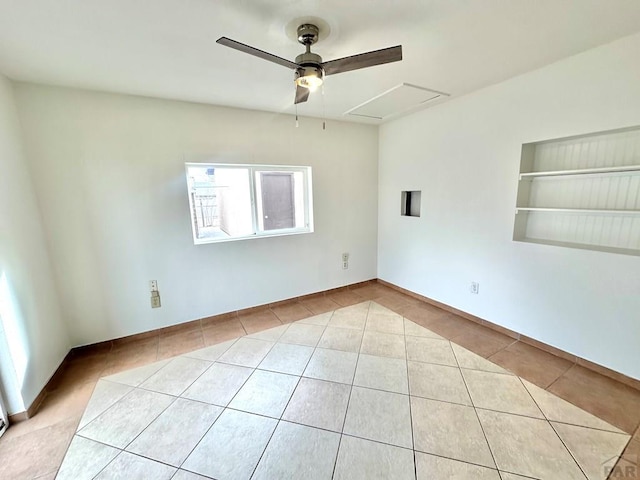 unfurnished room with light tile patterned floors, a ceiling fan, and built in features