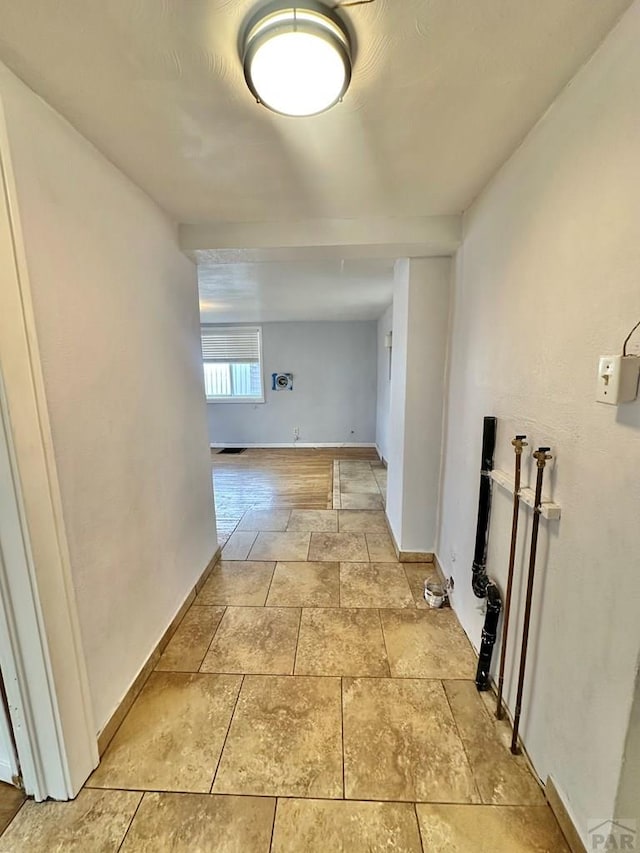 hallway featuring baseboards