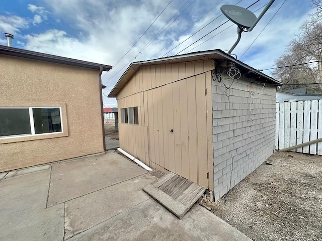 view of outbuilding featuring an outbuilding and fence